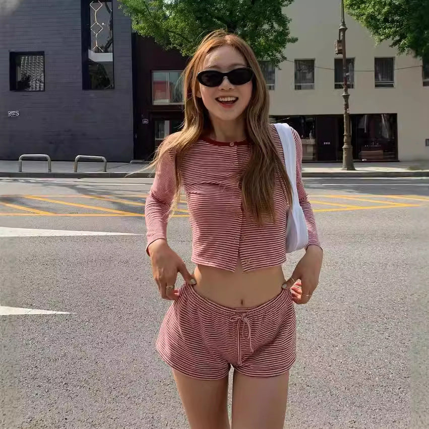 Two piece set of contrasting striped long sleeved T-shirt and low waisted drawstring tied shorts